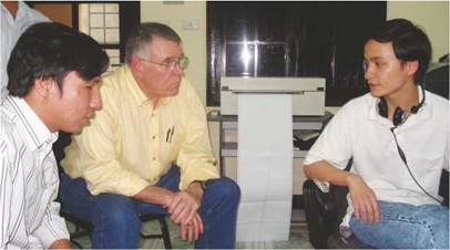 Photo: Mr. Dang Hoai Phuc (left) and Mr. Larry Campbell (center) meeting with a student