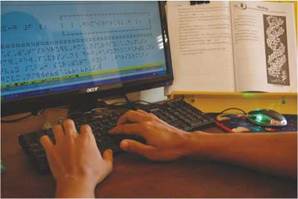 photo: a transcriber preparing textbook in braille file.